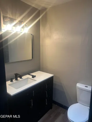 a bathroom with a sink toilet and mirror