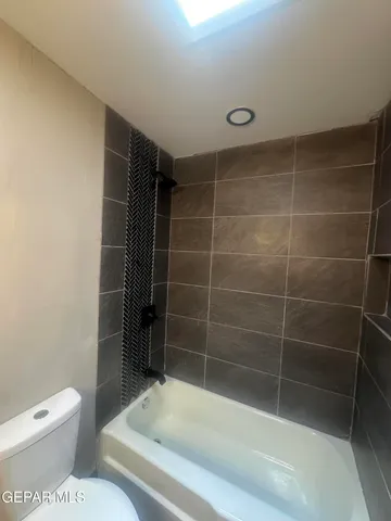 a bathroom with a toilet and shower