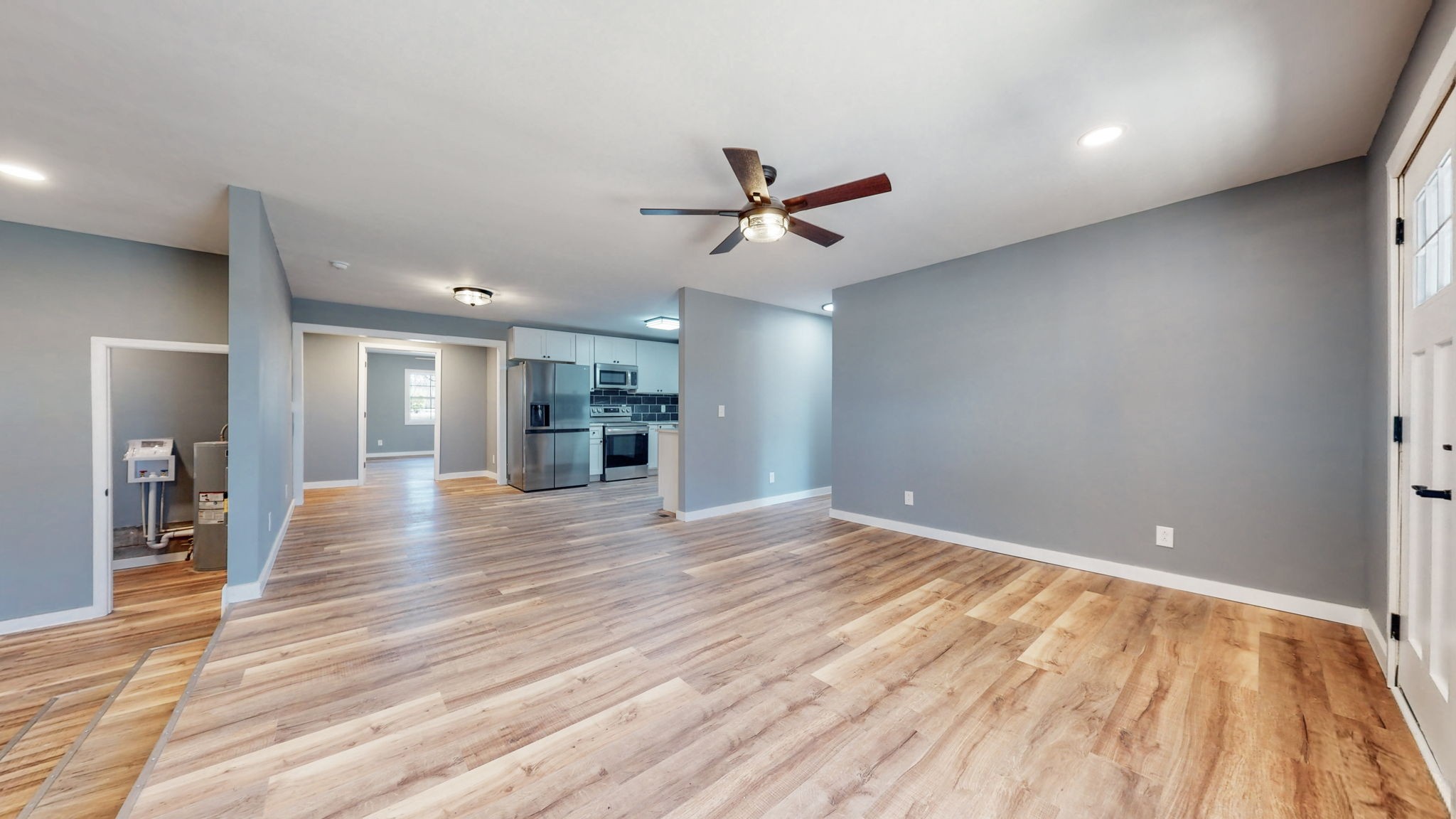 240 Myers Road Winchester, TN 37398 - Photo 7 of 46 an empty room with wooden floor and a ceiling fan