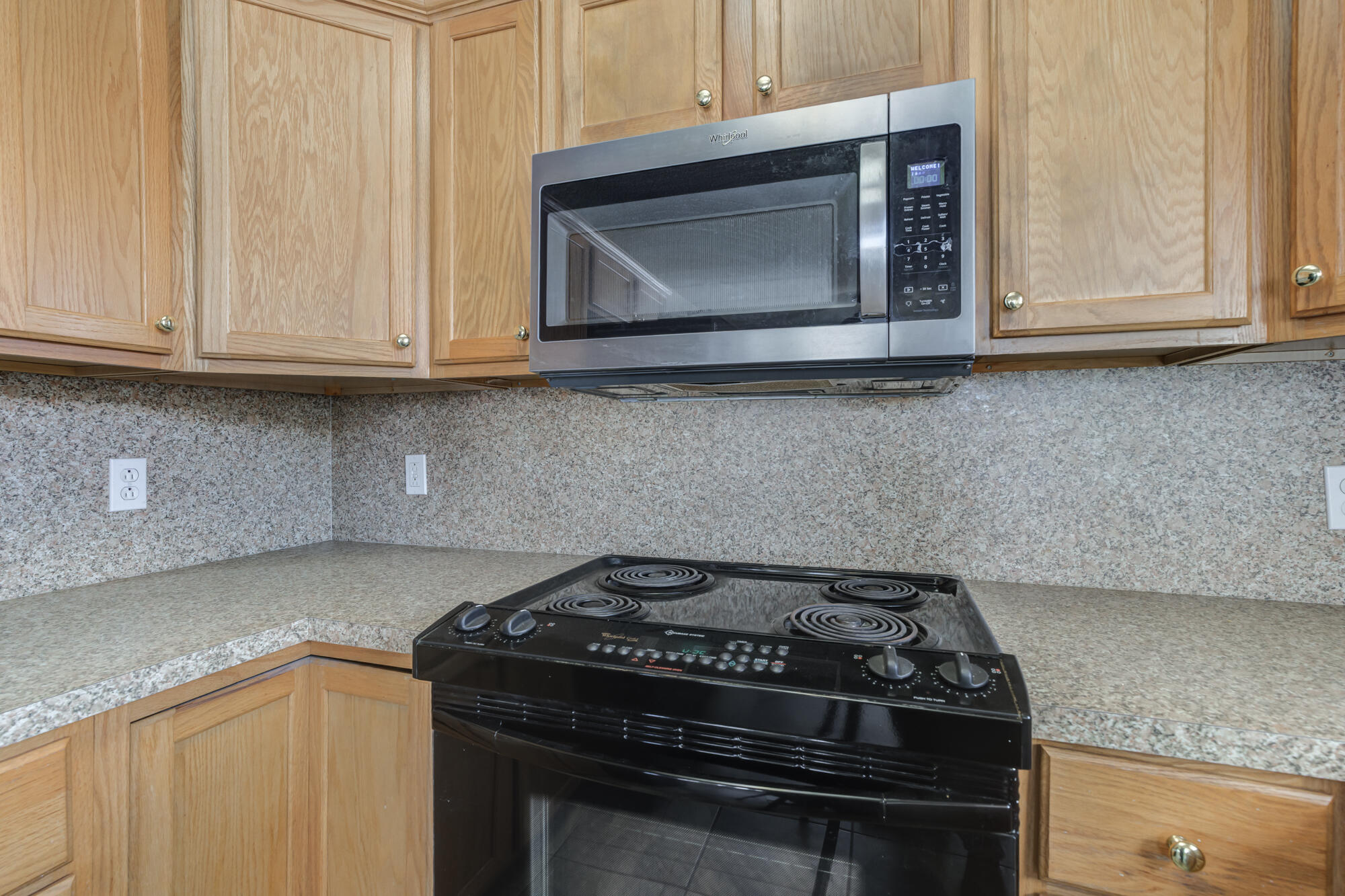 1903 77th Street Lubbock, TX 79423 - Photo 14 of 30 a kitchen with granite countertop white cabinets and stainless steel appliances
