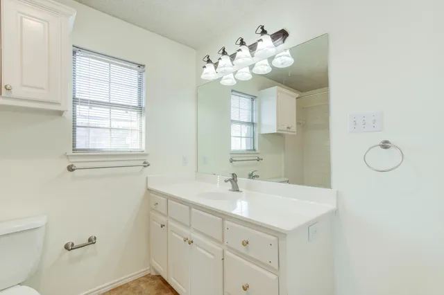 a bathroom with a sink vanity and mirror