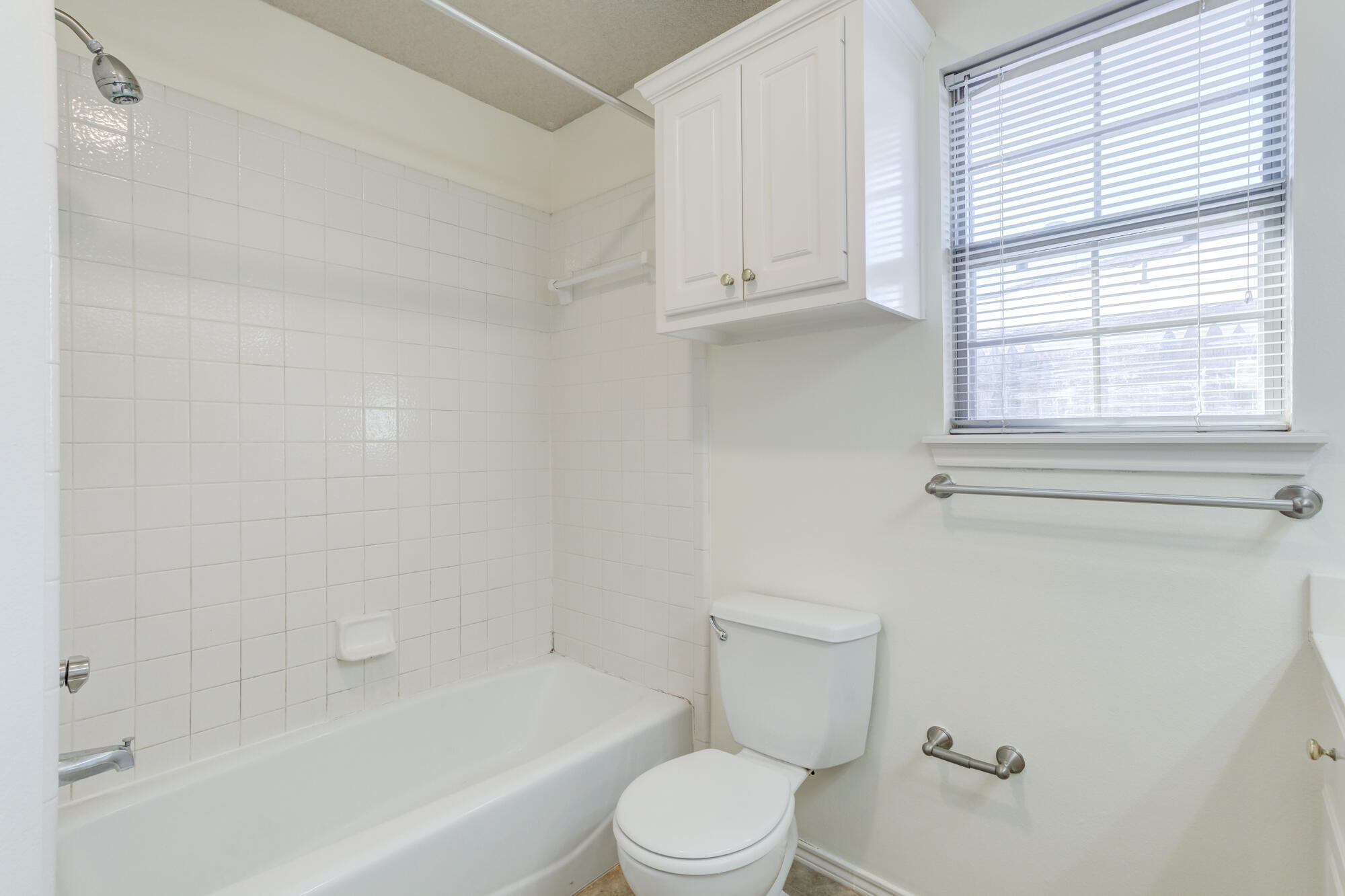 1903 77th Street Lubbock, TX 79423 - Photo 18 of 30 a bathroom with a toilet and bathtub