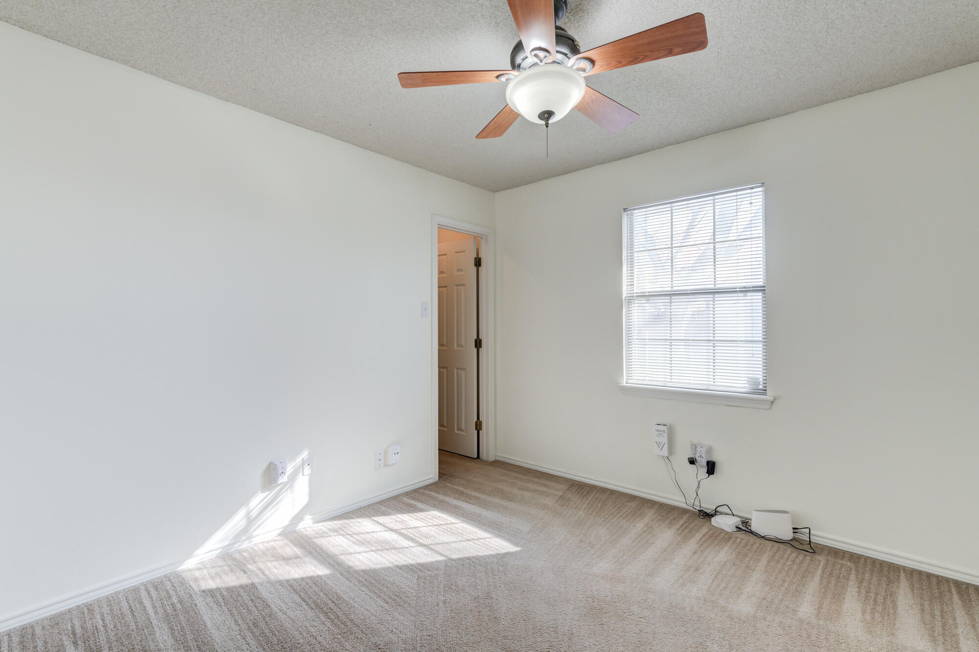 1903 77th Street Lubbock, TX 79423 - Photo 19 of 30 an empty room with windows and fan