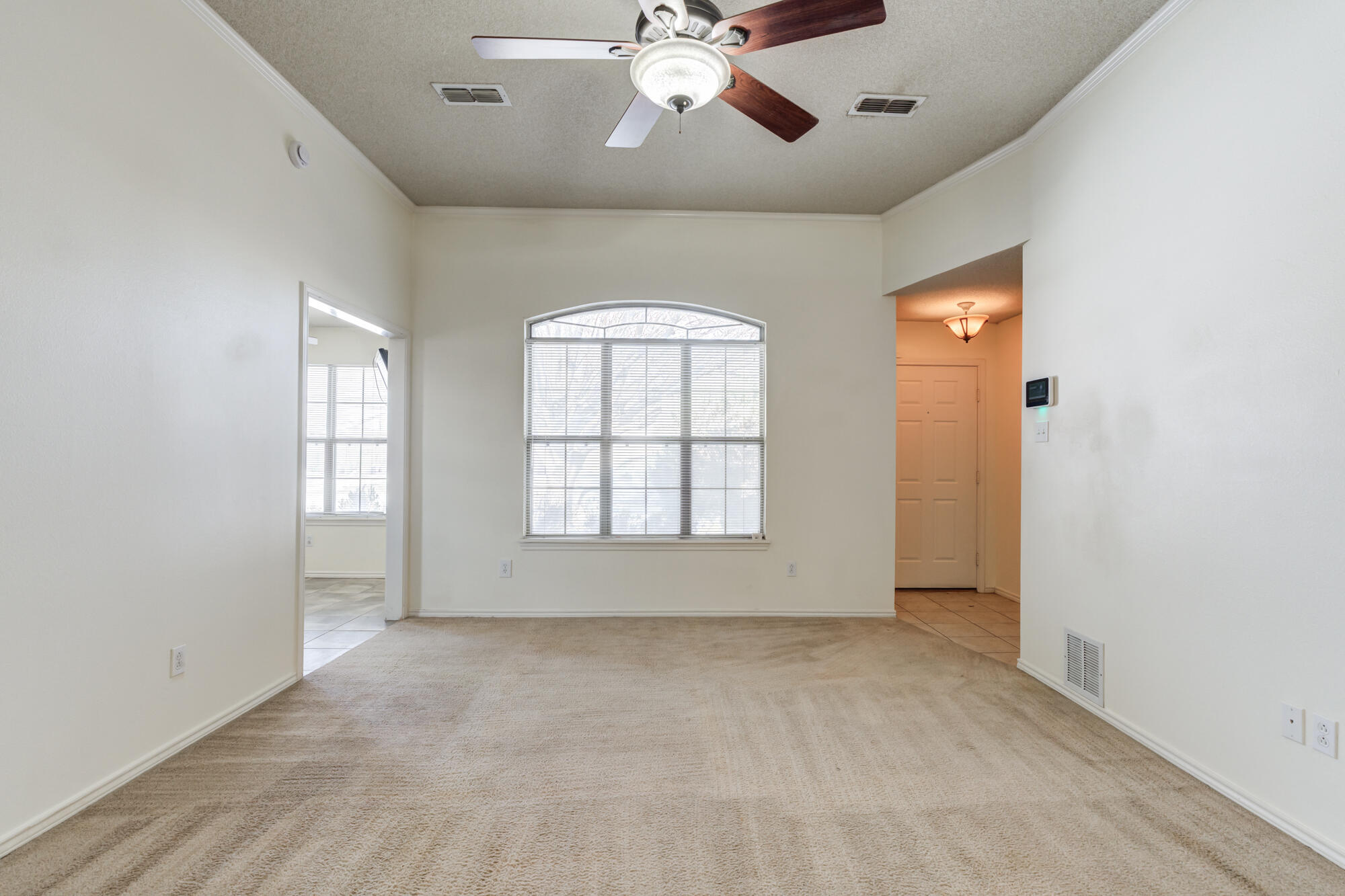1903 77th Street Lubbock, TX 79423 - Photo 2 of 30 an empty room with chandelier fan and windows