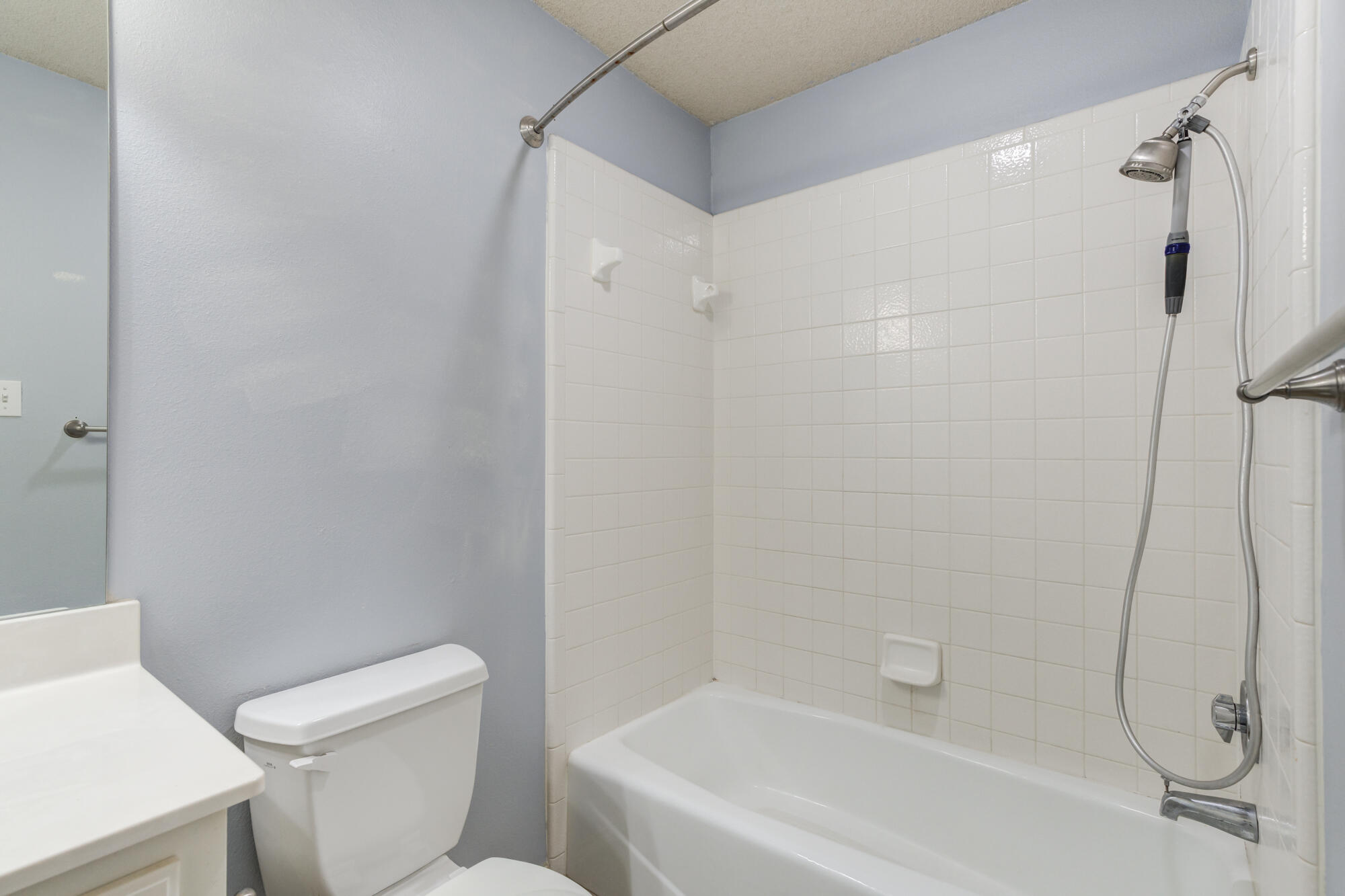 1903 77th Street Lubbock, TX 79423 - Photo 23 of 30 a white bath tub sitting next to a white toilet and sink