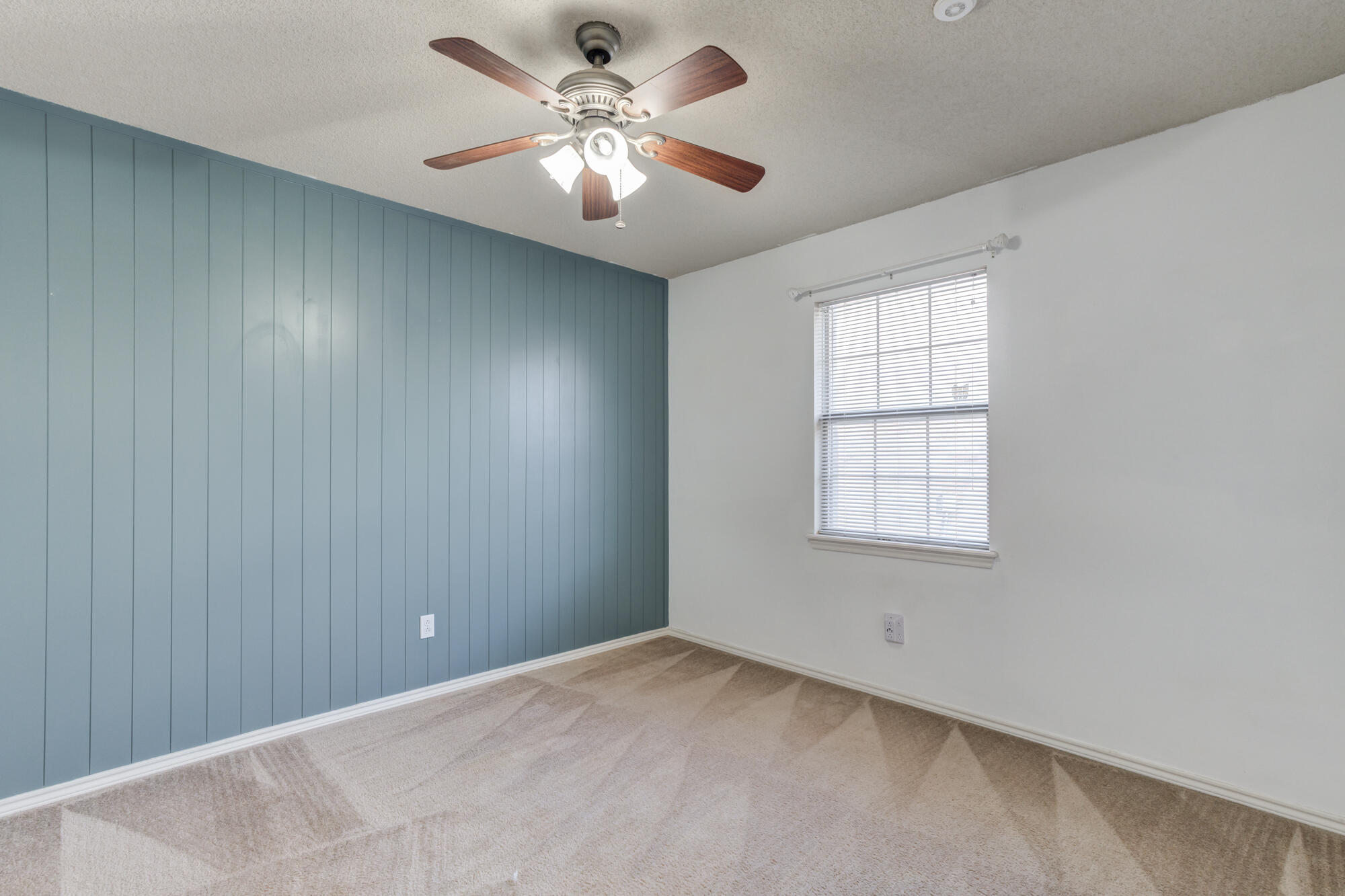 1903 77th Street Lubbock, TX 79423 - Photo 25 of 30 an empty room with windows and fan