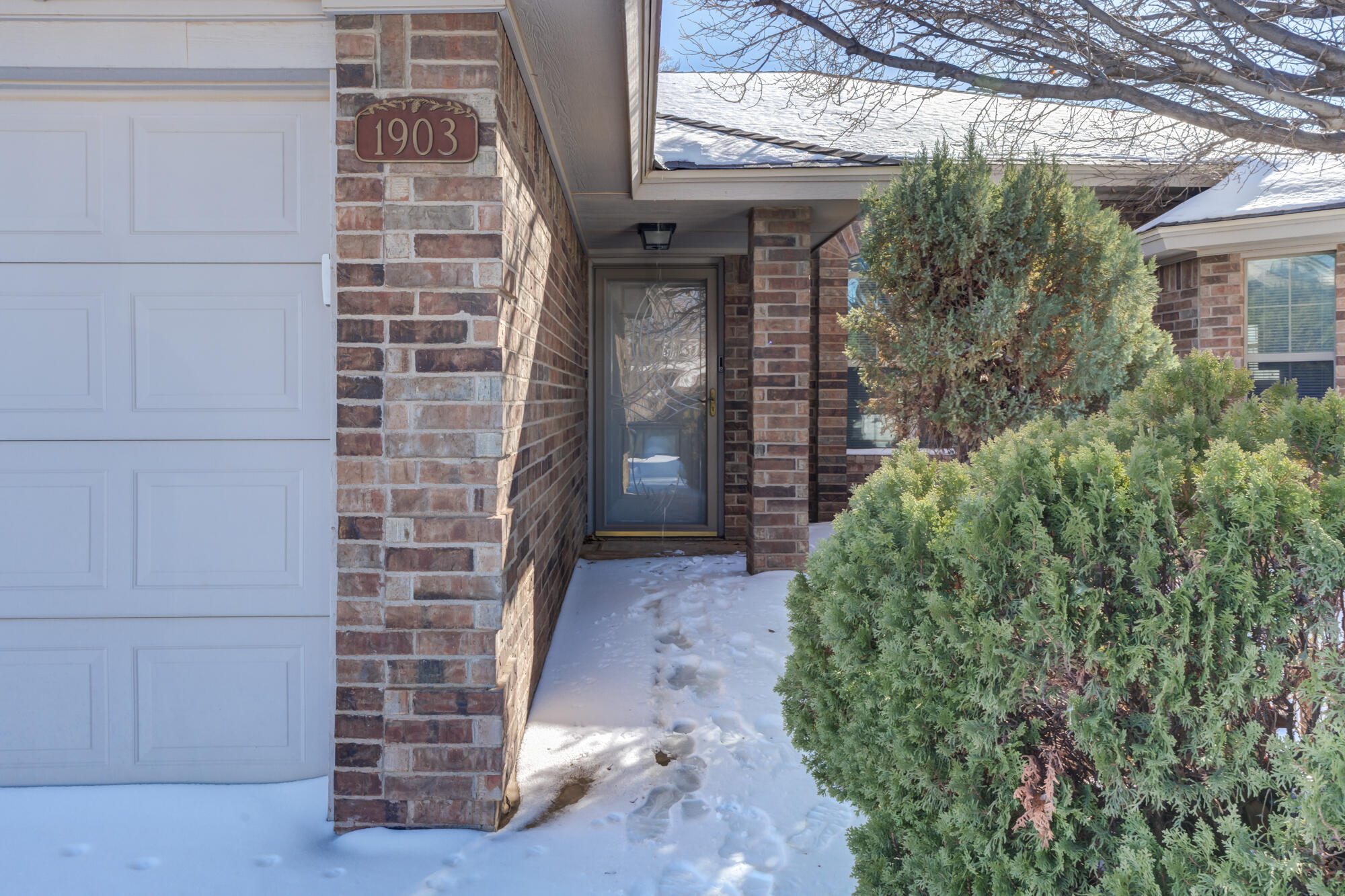 1903 77th Street Lubbock, TX 79423 - Photo 7 of 30 a view of a brick house with potted plants