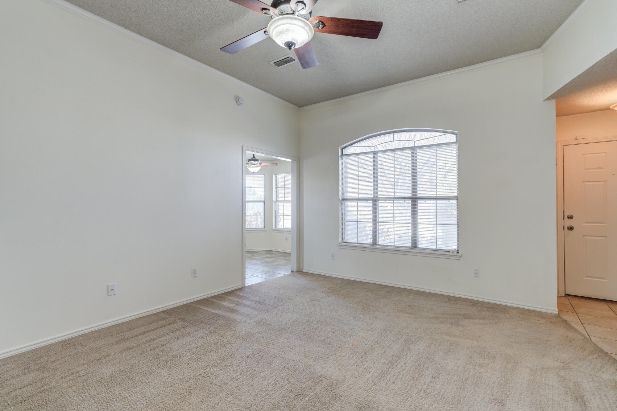1903 77th Street Lubbock, TX 79423 - Photo 9 of 30 an empty room with chandelier fan and windows