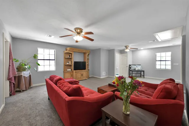 a bedroom with bed and a chandelier