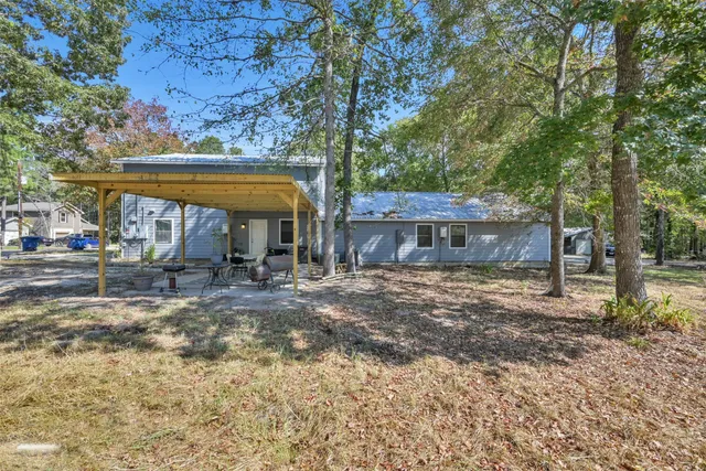 a view of a house with a yard and tree s