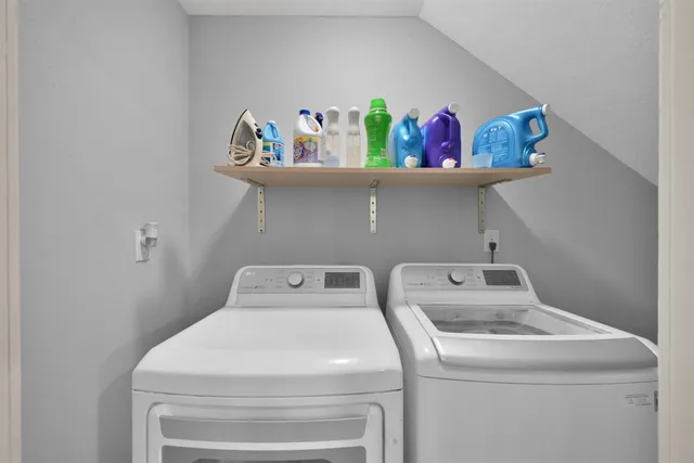a view of empty room with wooden floor and white walls