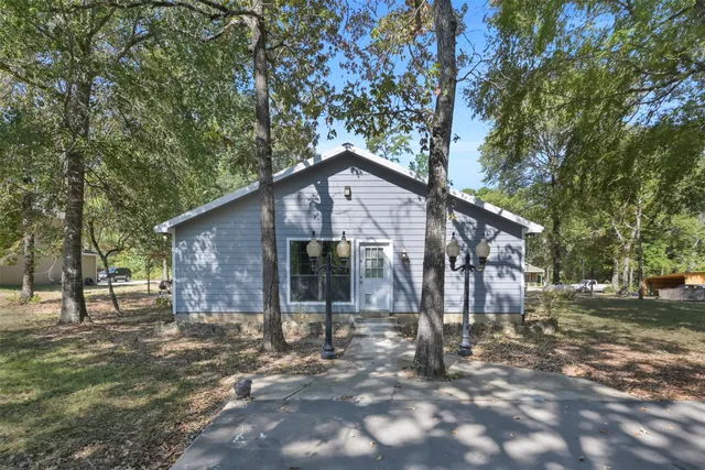 a large kitchen with stainless steel appliances kitchen island granite countertop a stove a sink a refrigerator and white cabinets