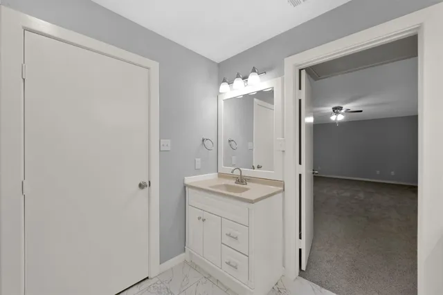 a bathroom with a tub a sink and a mirror