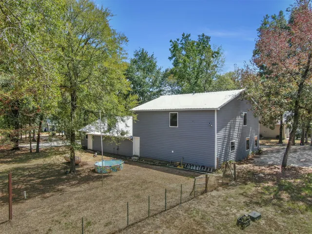 an aerial view of a house with outdoor space