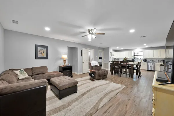 a living room with furniture and kitchen view