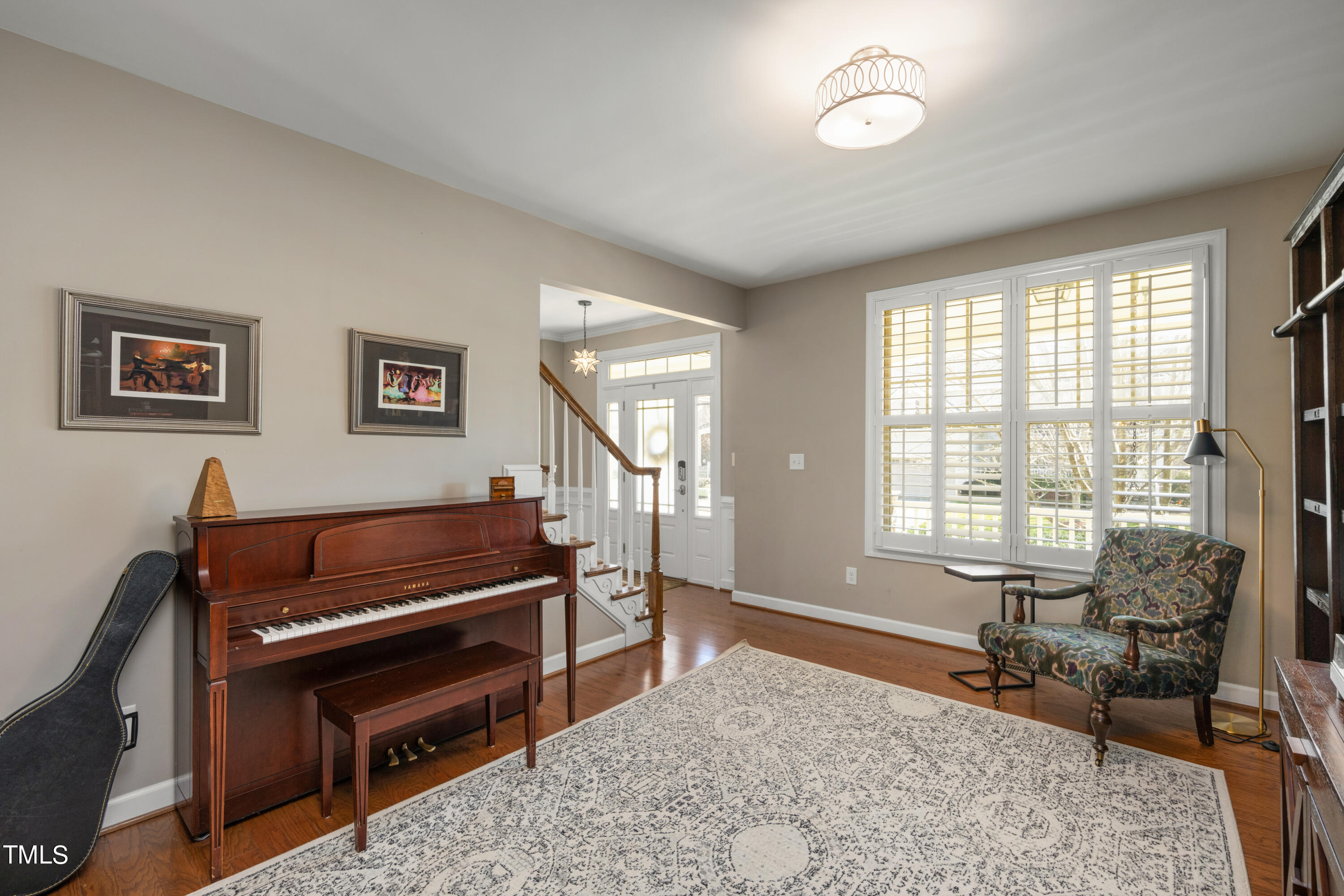 3020 Red Grape Drive Raleigh, NC 27607 - Photo 11 of 37 a living room with furniture a flat screen tv and a window