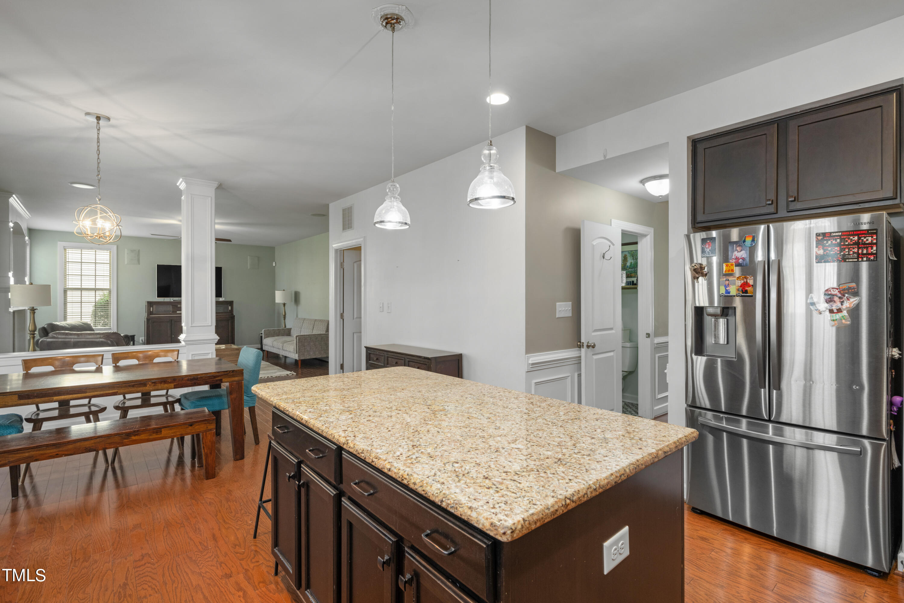 3020 Red Grape Drive Raleigh, NC 27607 - Photo 15 of 37 a kitchen with stainless steel appliances granite countertop a table chairs and a refrigerator