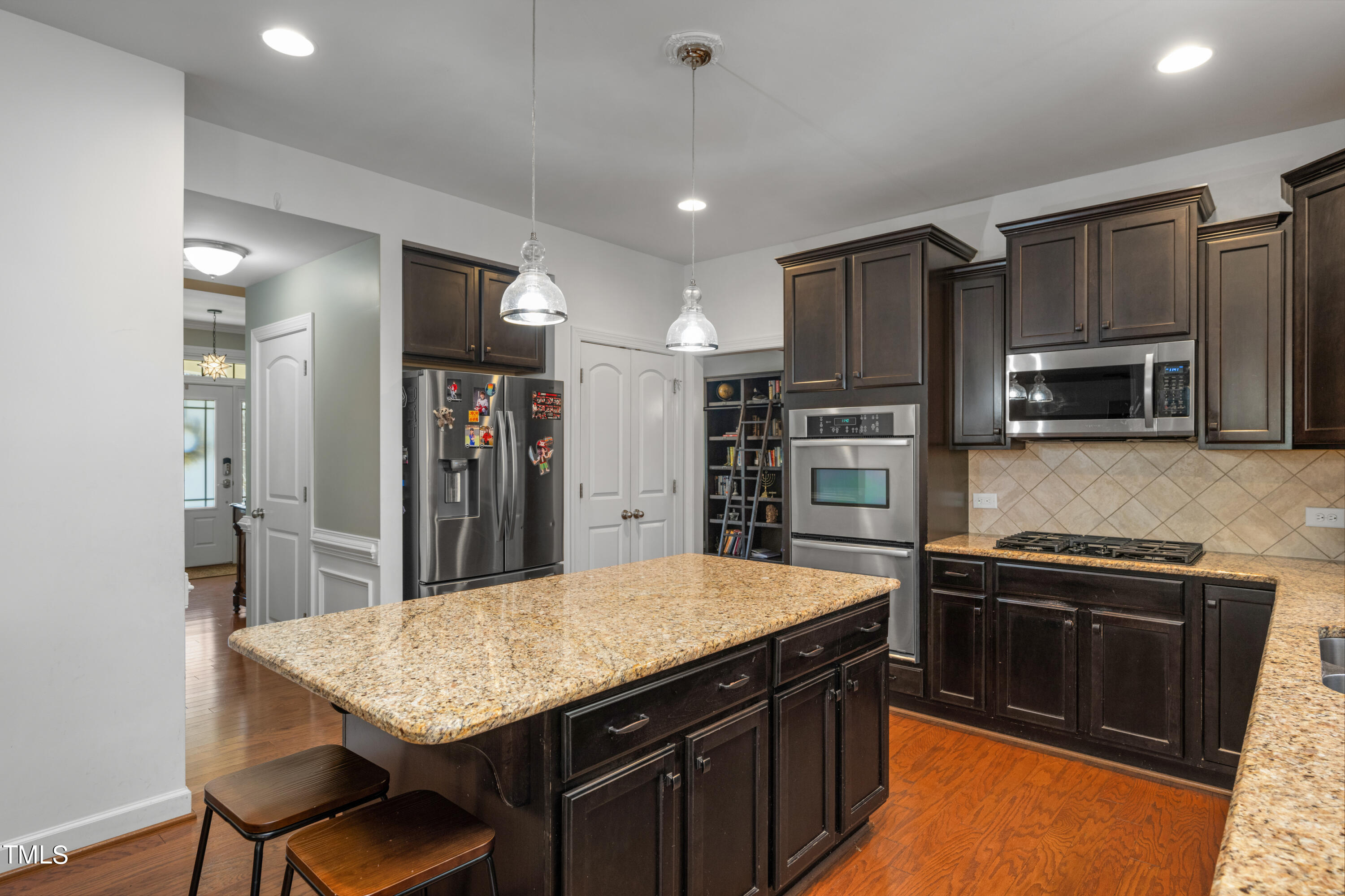 3020 Red Grape Drive Raleigh, NC 27607 - Photo 16 of 37 a kitchen with stainless steel appliances granite countertop a sink stove and refrigerator