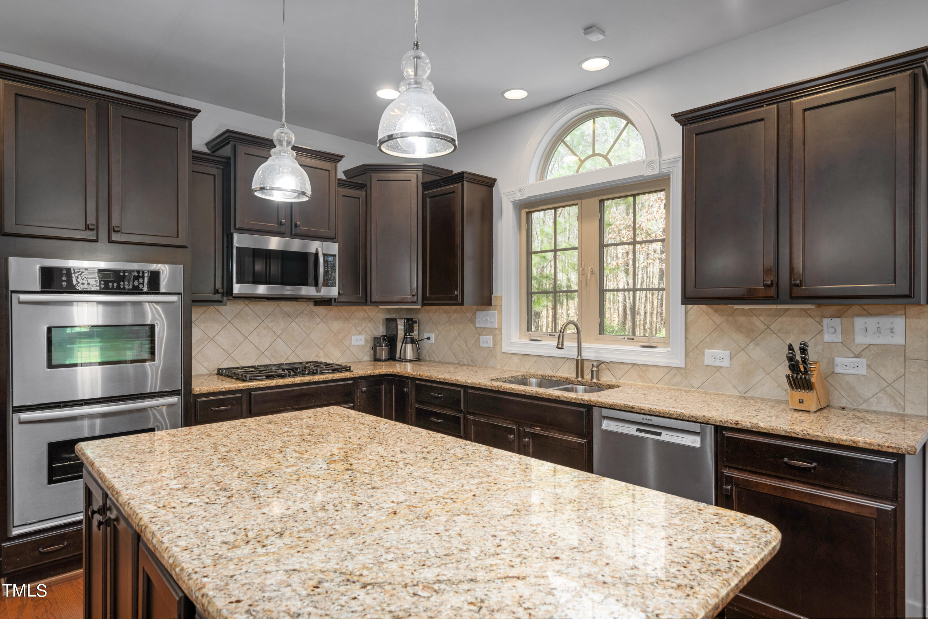 3020 Red Grape Drive Raleigh, NC 27607 - Photo 17 of 37 a kitchen with a sink stove and microwave