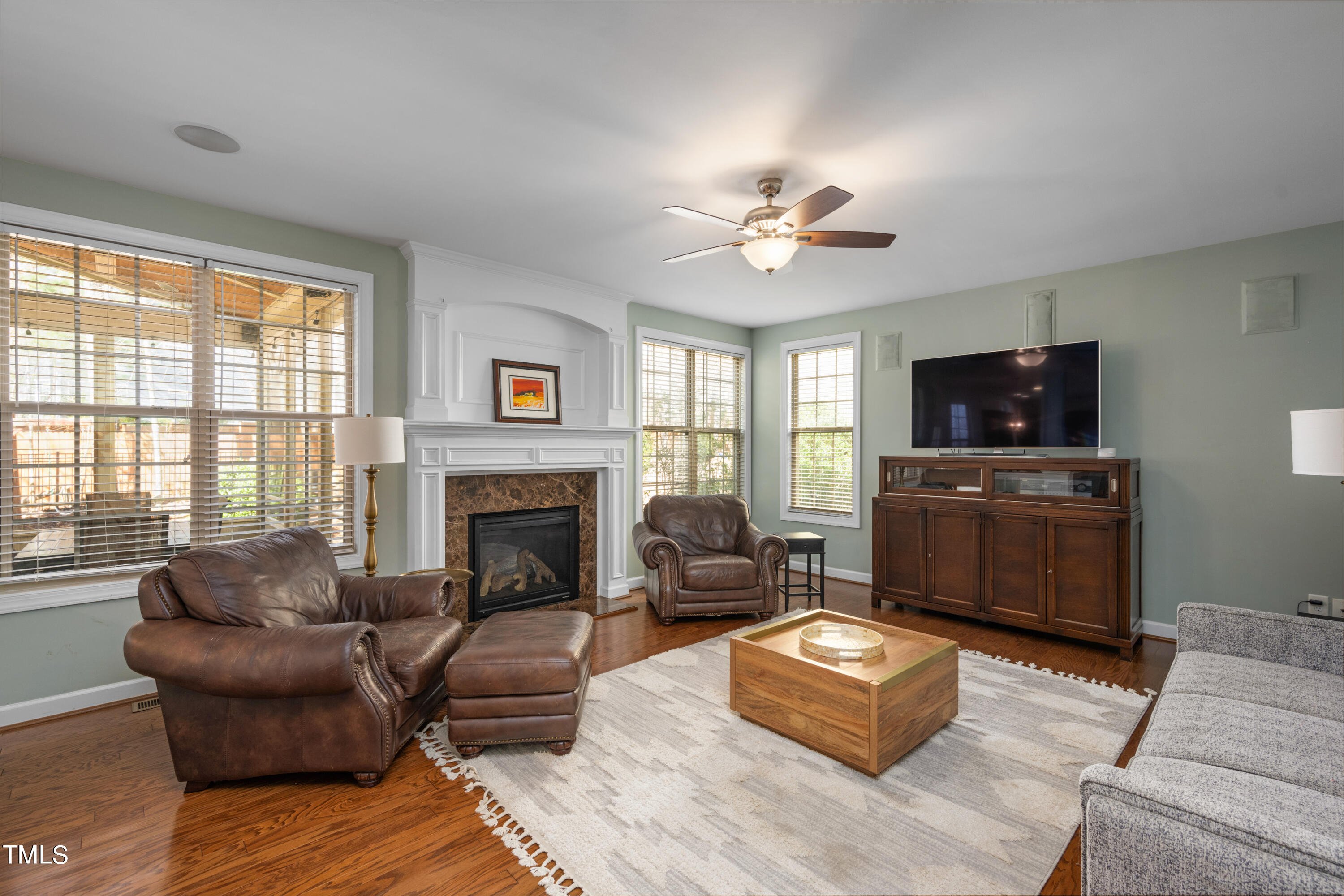 3020 Red Grape Drive Raleigh, NC 27607 - Photo 19 of 37 a living room with furniture a fireplace and a flat screen tv