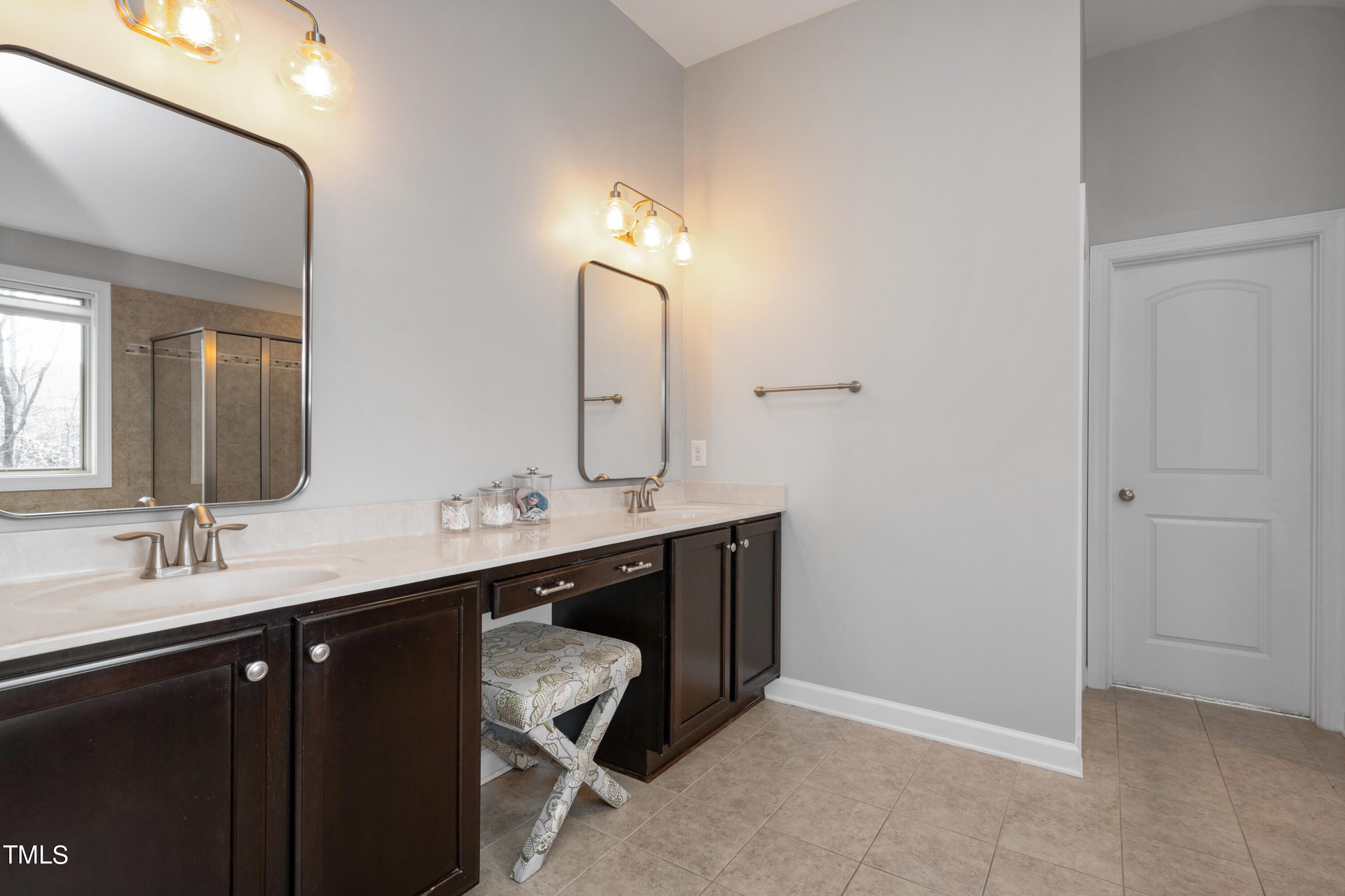 3020 Red Grape Drive Raleigh, NC 27607 - Photo 27 of 37 a bathroom with a double vanity sink and a mirror