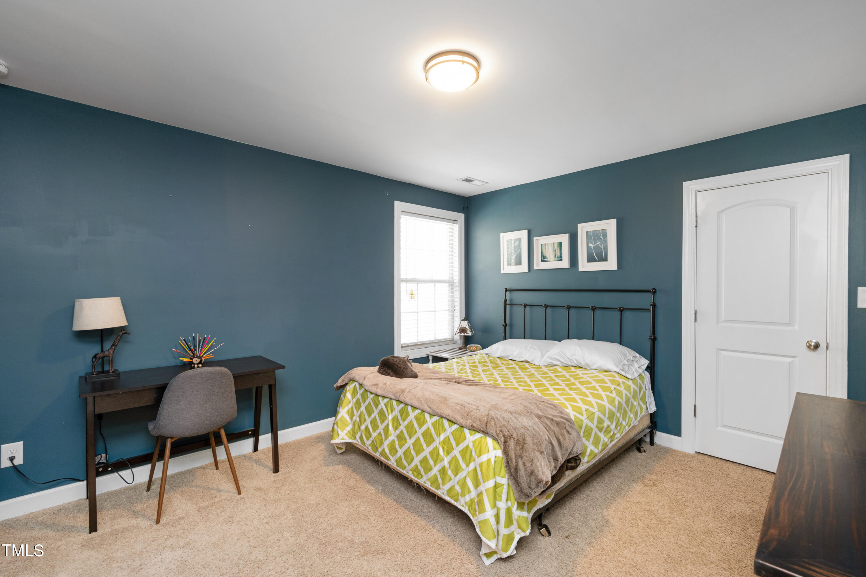 3020 Red Grape Drive Raleigh, NC 27607 - Photo 32 of 37 a bedroom with a bed and a lamp on dresser