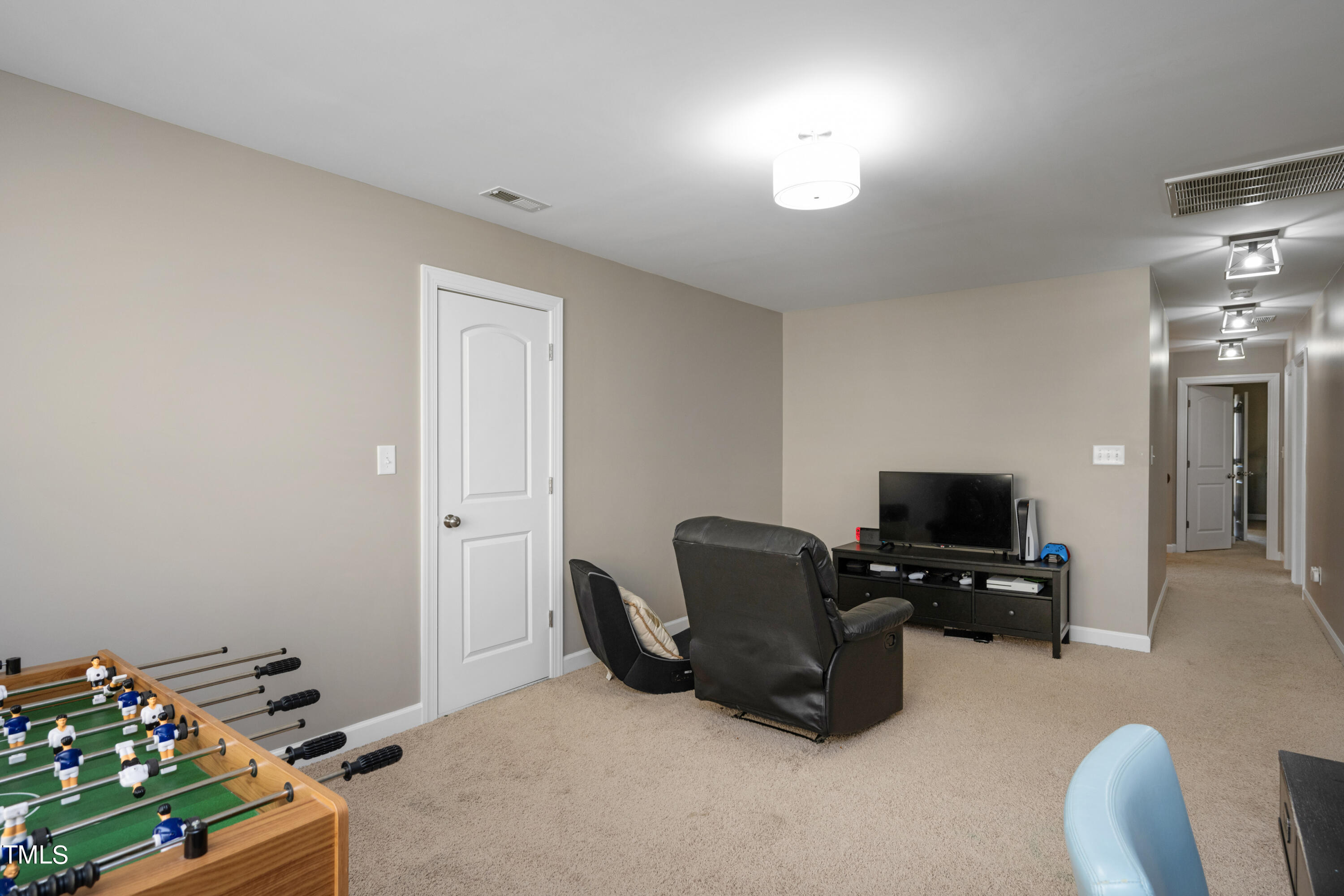 3020 Red Grape Drive Raleigh, NC 27607 - Photo 35 of 37 a room with furniture and a flat screen tv