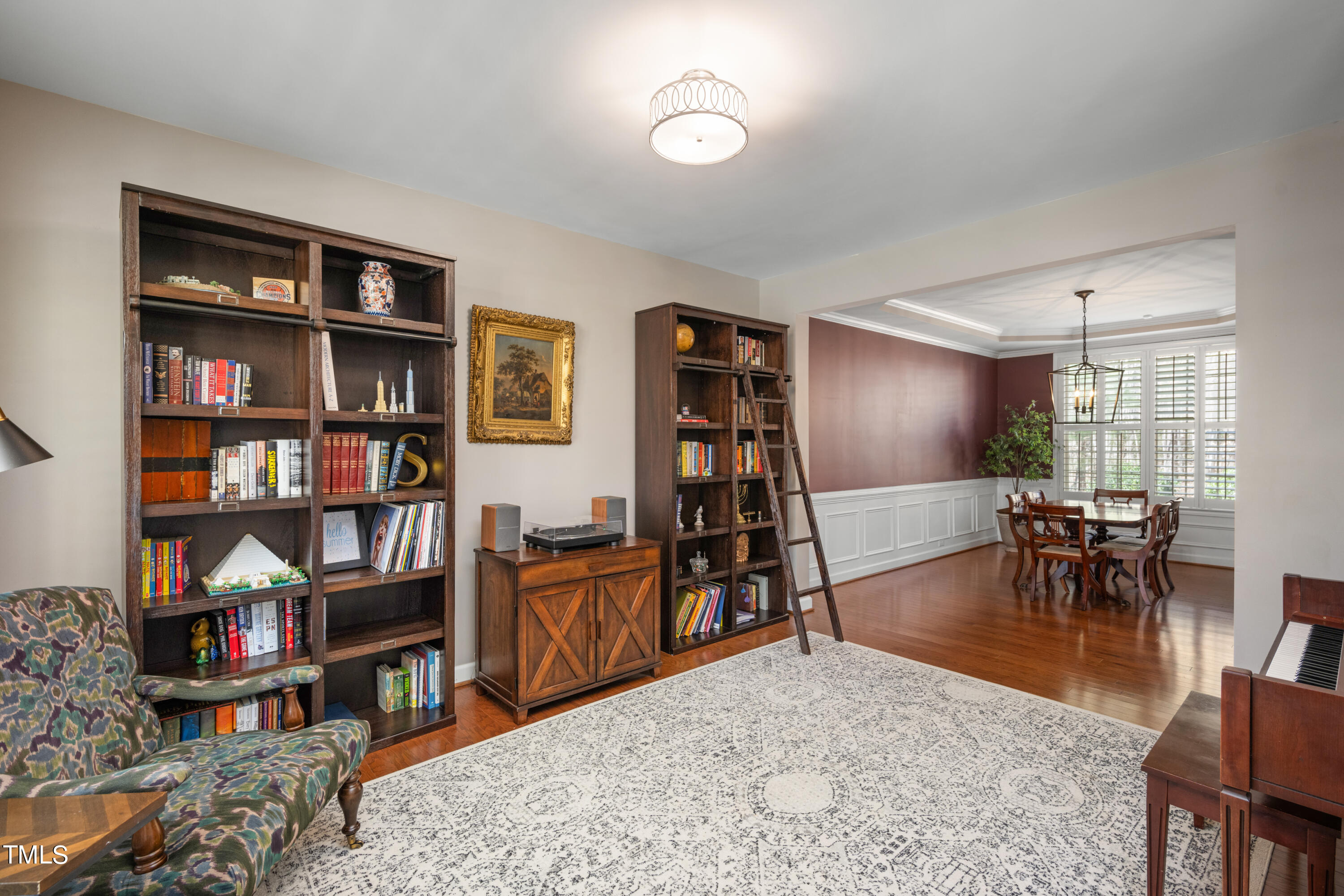 3020 Red Grape Drive Raleigh, NC 27607 - Photo 9 of 37 a living room with furniture a rug and a book shelf