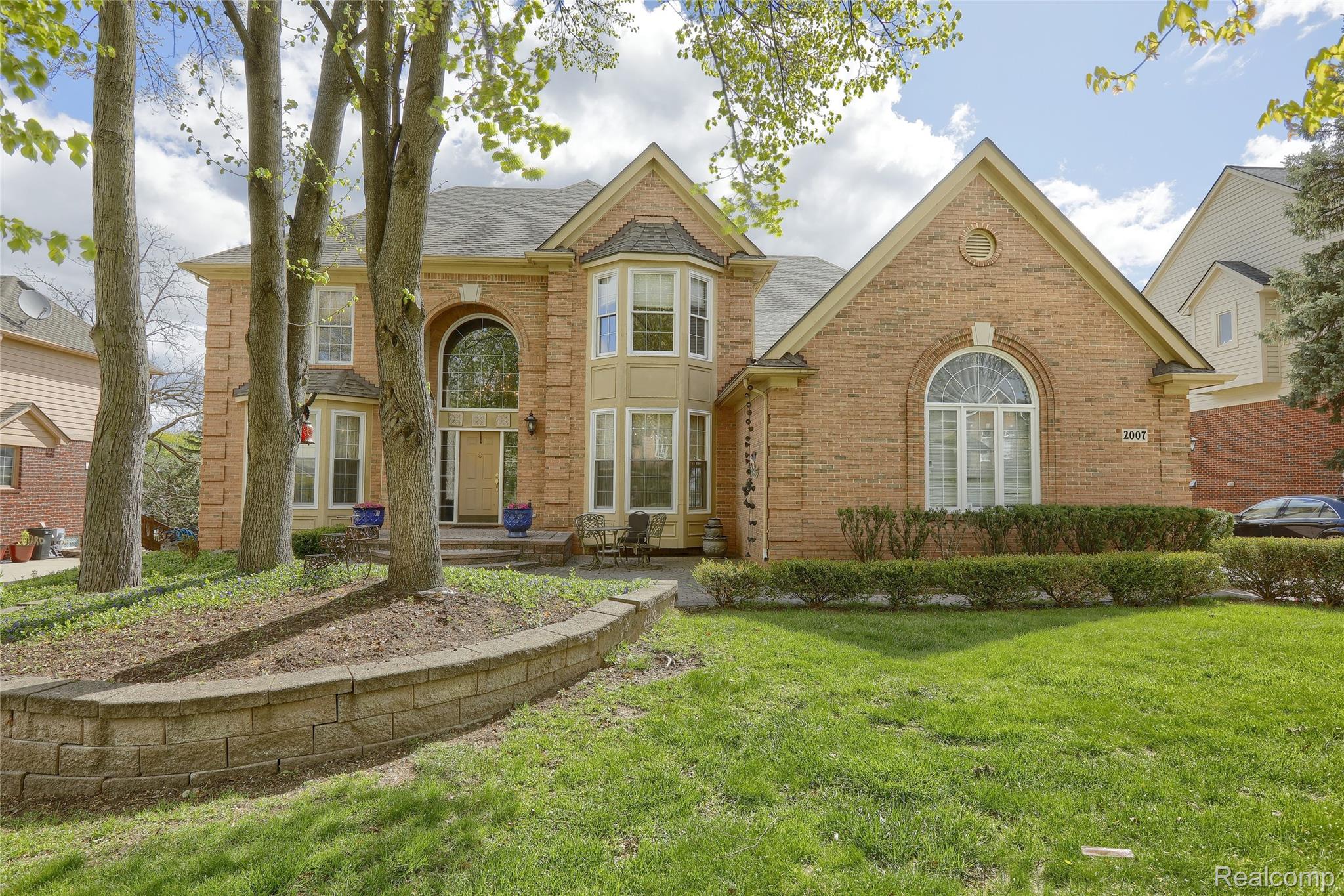 2007 Mapleridge Road Rochester, MI 48309 - Photo 1 of 45 View of front of property featuring brick siding, a front lawn, and a shingled roof
