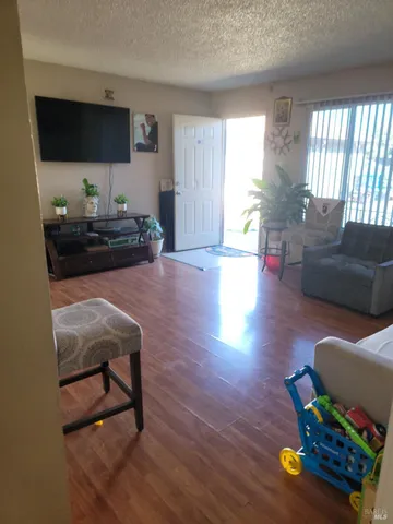 a bedroom with a bed and dresser next to a window