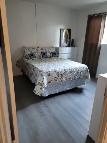 a kitchen with stainless steel appliances a stove a sink and white cabinets