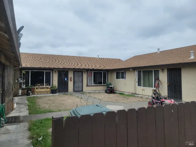 a front view of a house with yard and seating space