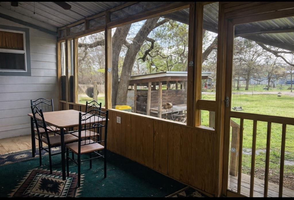 106 1733 Cr Road Clifton, TX 76644 - Photo 6 of 10 a view of a chairs and table in patio with a yard