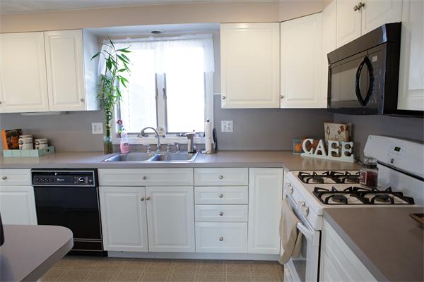 1 Arnold Road Peabody, MA 01960 - Photo 8 of 21 a kitchen with stainless steel appliances a white stove top oven and sink
