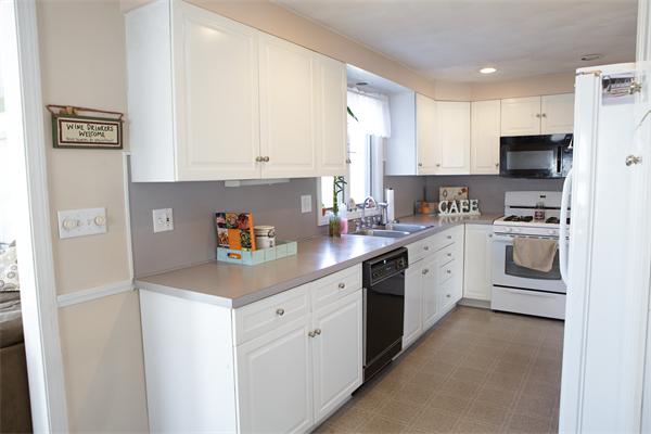 1 Arnold Road Peabody, MA 01960 - Photo 9 of 21 a kitchen with stainless steel appliances a sink a stove a refrigerator a center island and cabinets