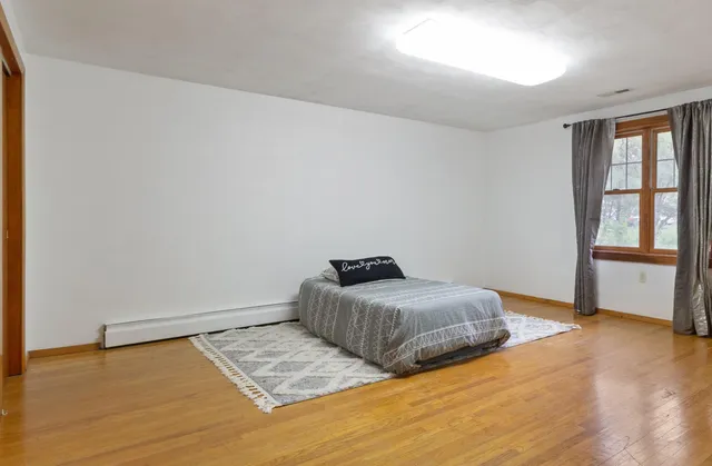 a bedroom with bed and window