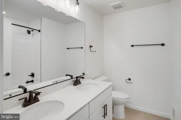 a bathroom with a sink toilet a mirror and vanity