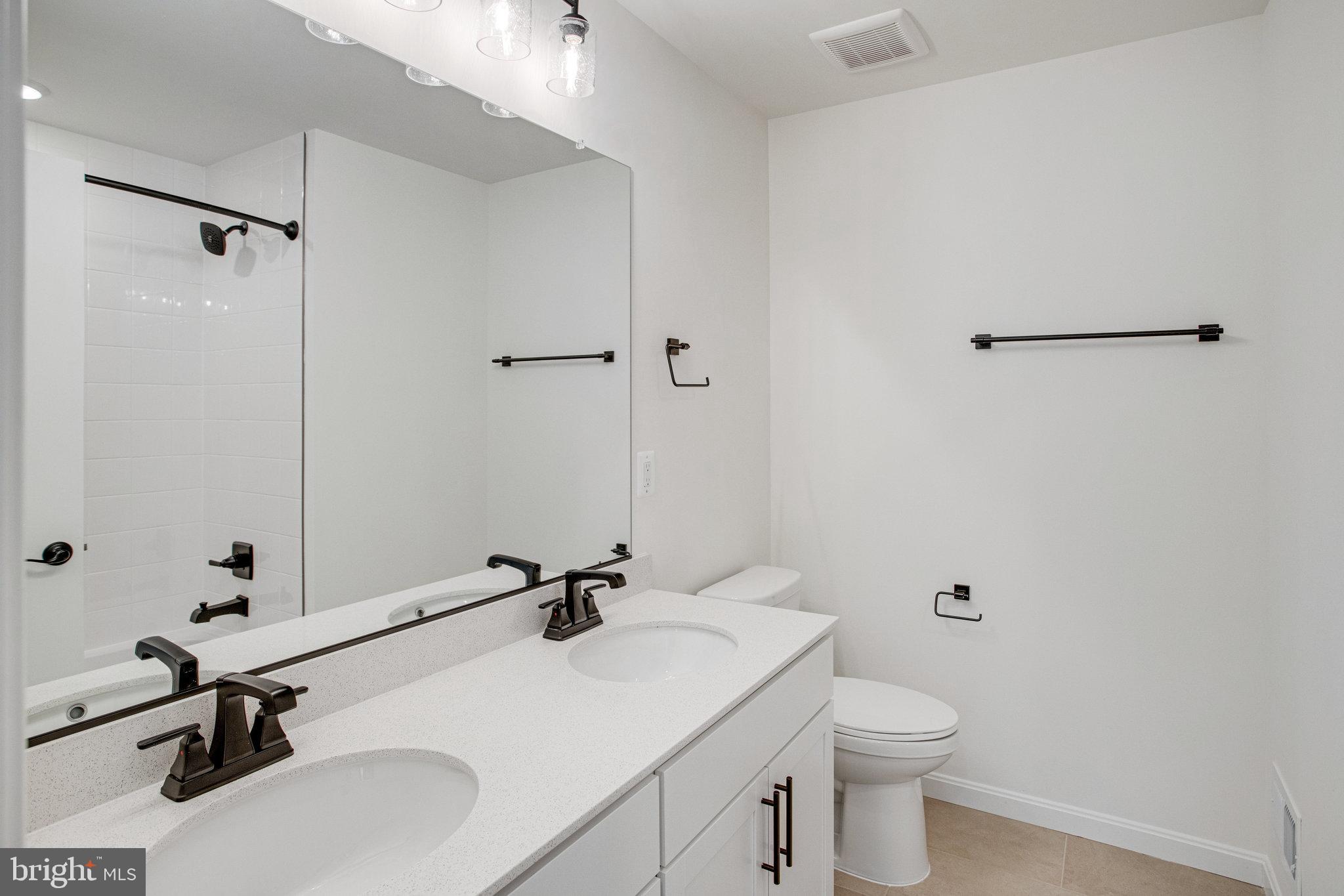 608 Clover Lane Orange, VA 22960 - Photo 12 of 38 a bathroom with a sink toilet a mirror and vanity