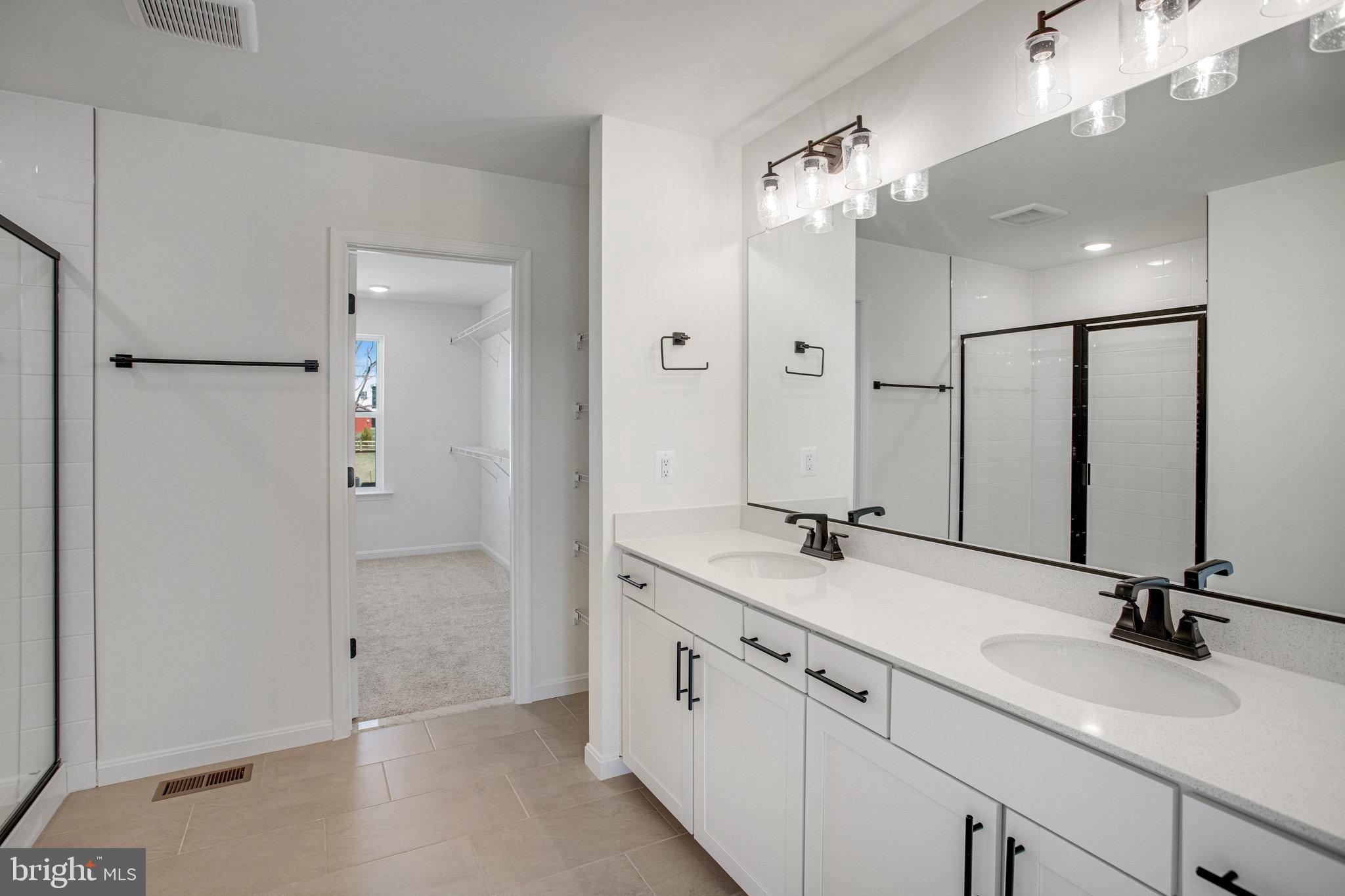 608 Clover Lane Orange, VA 22960 - Photo 19 of 38 a bathroom with double sink and a mirror