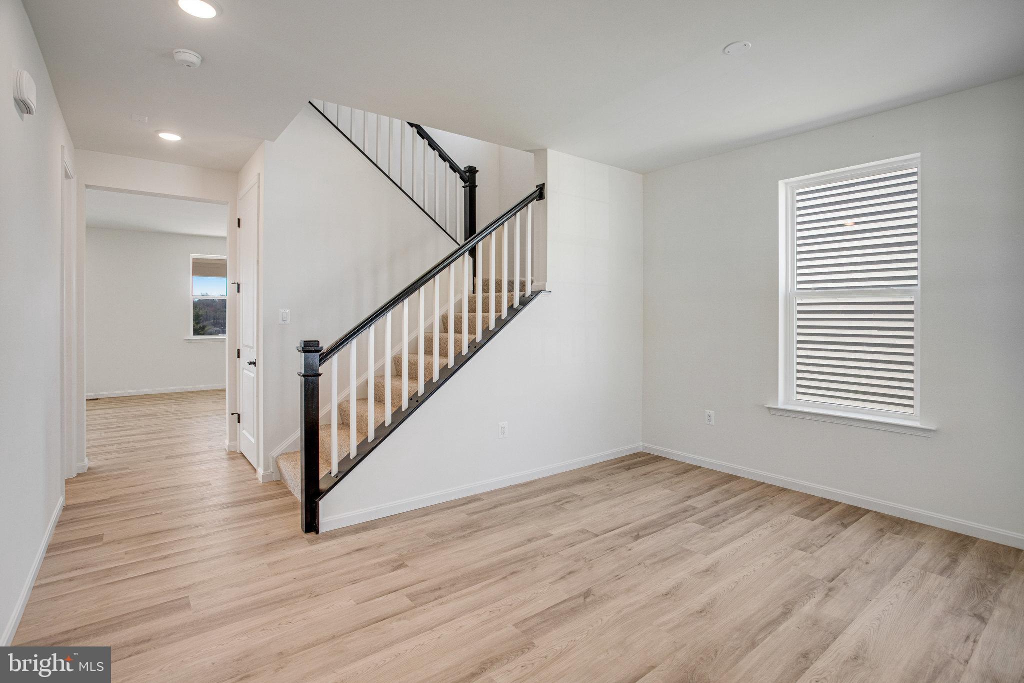 608 Clover Lane Orange, VA 22960 - Photo 27 of 38 a view of an empty room with wooden floor and a window