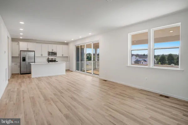 a kitchen with stainless steel appliances a stove a sink and a microwave