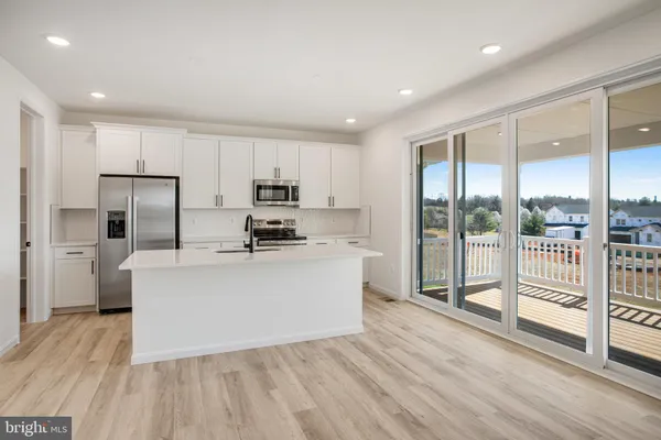 a kitchen with stainless steel appliances a sink and cabinets