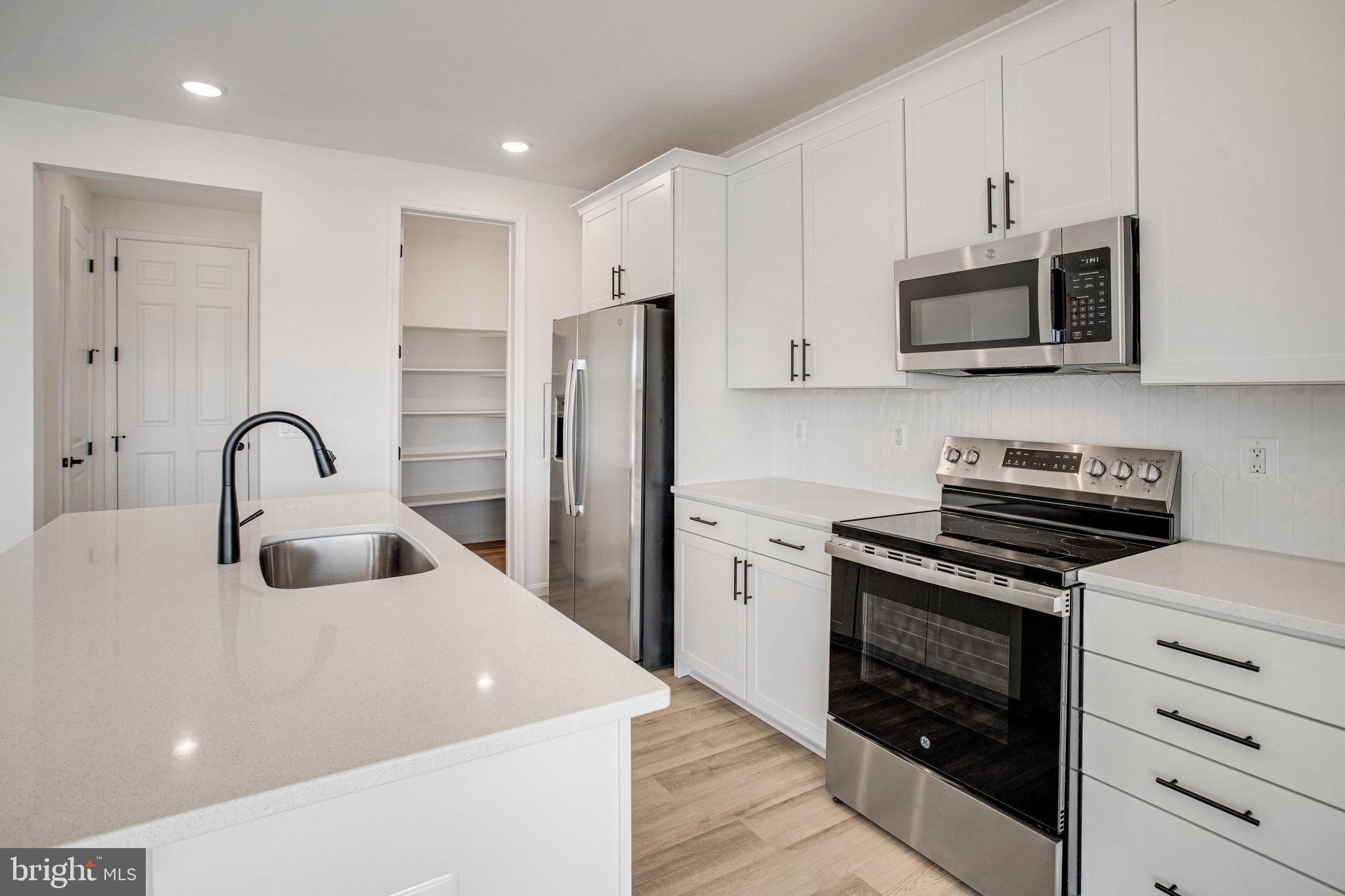 608 Clover Lane Orange, VA 22960 - Photo 34 of 38 a kitchen with stainless steel appliances a stove a sink and a microwave