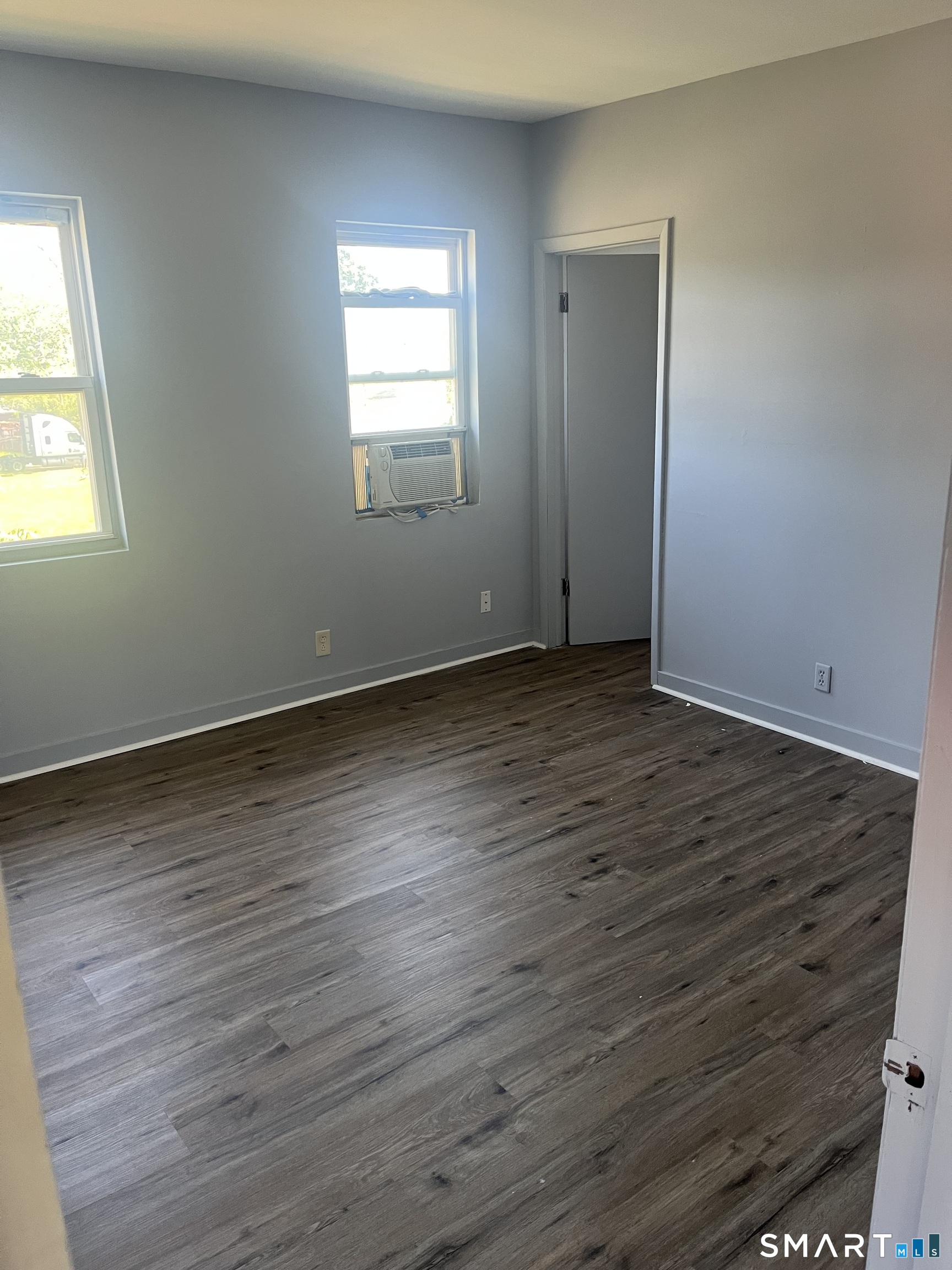 288 Cook Avenue Meriden, CT 06451 - Photo 9 of 11 an empty room with wooden floor and windows