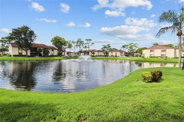 a view of a lake with houses in the back