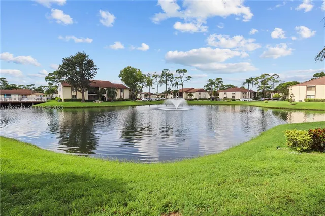 a view of a lake with houses in the back