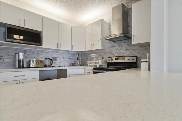 a kitchen with stainless steel appliances and white cabinets
