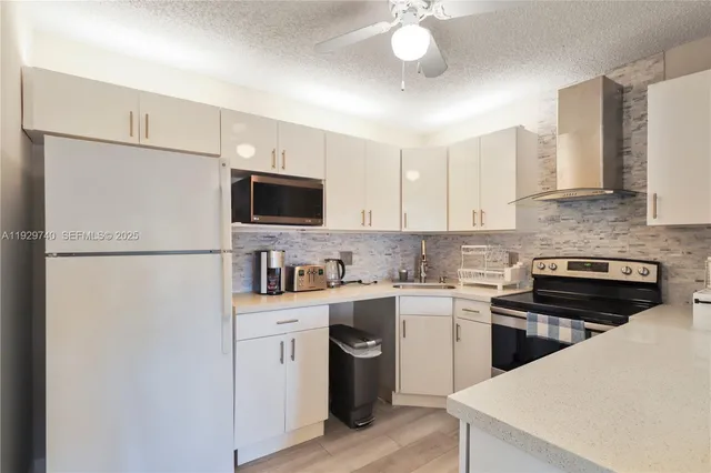 a kitchen with a refrigerator stove and microwave