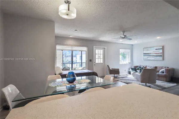 a living room with furniture a chandelier and a window