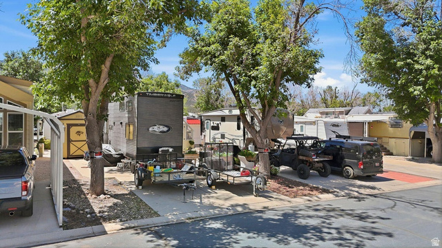 416 Kari Parowan, UT 84761 - Photo 3 of 14 Paved parking area featuring mature trees providing shade